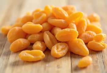 Dried apricots in a bowl with fresh apricots and honey