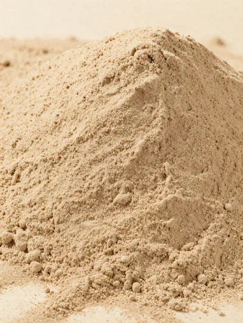 Light brown chestnut flour in a rustic bowl on a wooden surface