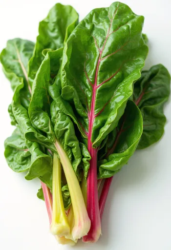 Colourful Swiss chard leaves on chopping board in natural light