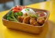 Karaage bento box with crisp chicken, rice and fresh vegetables