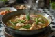 Sinigang stew served with spicy pork and vegetables