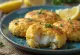 Fishcake with lemon zest served with fresh lemon slices and salad