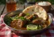 Paye with fresh coriander, served with lime slices and green chilli