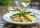Creamy risotto with fresh green asparagus, sprinkled with Parmesan, served Italian style