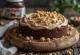 Nutella mascarpone cake decorated with whipped cream and chocolate shavings