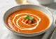 Creamy courgette and tomato soup served in a bowl