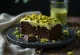 Pistachio chocolate cake decorated with chocolate and pistachios