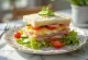 Classic Smörgåstårta decorated with eggs, ham and vegetables