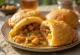 Vetkoek in golden brown spherical form, served with colourful vegetable curry