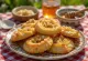 Melomakarona soaked in honey syrup, served sprinkled with ground walnuts