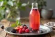 Probiotic fruit-flavoured kombucha served in a bottle with colourful fruit pieces