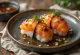 Pan-fried salmon onigiri, served with sesame seeds and nori seaweed