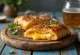 Stromboli with smoked cheese served, rich smoked cheese on top, crispy outside and soft inside.