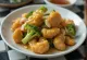 Broccoli tangsuyuk with golden brown chicken pieces, served with fresh broccoli
