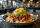 Burrito bowl with beef, rice, beans, corn and cheese