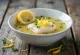 Psarosoupa refreshed with lemon juice, rich fish soup served with fresh olive oil and lemon juice