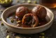 Chocolate stuffed Gulab Jamun coated in rich chocolate, soaked in syrup