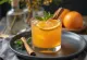 Refreshing rum orange juice in a glass with ice and orange slice