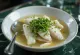 Psarosoupa sprinkled with parsley, rich fish soup served with fresh olive oil and lemon juice