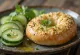 Bagel with hummus and fresh cucumber, garnished with parsley