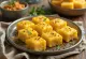 Cheese Dhokla served as golden brown, cheesy pieces with fresh spices