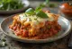 Moussaka with tomato, meat and curd cheese layers