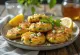 Kolokithokeftedes with feta cheese, served with fresh parsley and lemon slices