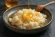 Creamy risengrød served drizzled with honey