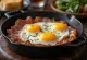 Smoked ham with fried eggs served with fresh bread