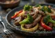 Lomo saltado served with beef and roasted vegetables