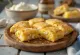 Golden baked cornmeal squares with visible chunks of white feta cheese